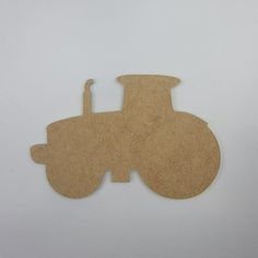 a piece of cardboard cut out to look like a tractor or farm vehicle on a white background