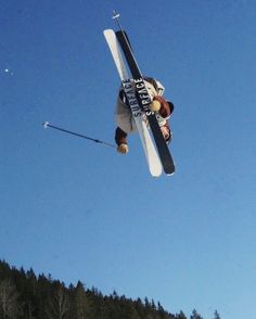 a man flying through the air while riding skis