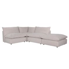 a white sectional couch with pillows on it's back and the seat folded out