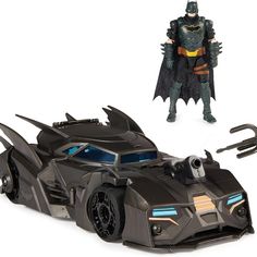 the batmobile from batman movie is shown in front of a white background and an action figure