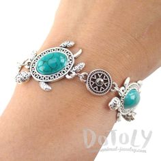 This bracelet features not one but three turtle shaped charms in silver with turquoise beads, it's surrounded by decorative beads with rhinestone details and closes with a clasp! For more unique animal inspired bracelets just check out our store! Store FAQ | Shipping Info | Returns & Exchanges Size: Each turtle charm measures 2.3 cm wide by 3.3 cm tall, the entire bracelet measures 21.5 cm (8.5 inches) long Material: Tin Alloy Adjustable Turquoise Metal Charm Bracelet, Bohemian Turquoise Charm Bracelet With Lobster Clasp, Inspired Bracelets, Animal Bracelet, Turtle Jewelry, Turtle Love, Bracelet In Silver, Wrist Jewelry, Turtle Charm