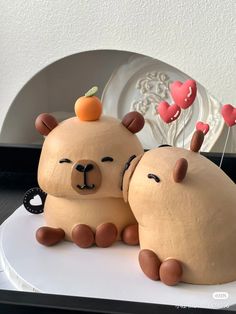 two cakes made to look like animals sitting next to each other