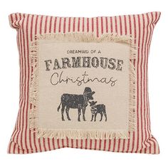 a red and white striped pillow with a black cow on it's side, saying dreaming of a farmhouse christmas