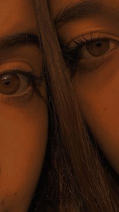 a woman's face is reflected in the reflection of another person's eye