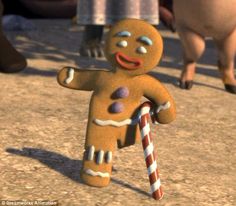 an animated ginger man holding a candy cane