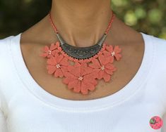 Product: Light pink, flower design, boho style, beaded, adjustable oya crochet bib necklace. Jewelry and accessory for women. Gift for her. 🔘 This handmade crocheted elegant oya-needlework necklace includes pink flower designs and beads embellished on the bronze connector. Let it make you the center of attraction! 🔘 Also a fantastic gift for your beloved ones! 📌 Material: Delicate and strong polyester thread, bronze connector and crochet necklace chain. 📌 Structure: Oya crocheted floral eleg Handmade Bohemian Flower Necklace For Spring, Bohemian Handmade Flower Necklace For Spring, Bohemian Flower Necklace For Beach, Bohemian Beach Flower Necklace, Handmade Bohemian Beaded Necklaces For Spring, Bohemian Coral Beaded Necklaces, Handmade Bib Necklaces For The Beach, Handmade Coral Bohemian Beaded Necklaces, Handmade Coral Beaded Bohemian Necklace