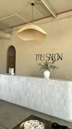 a table with plates and bowls on it in front of a sign that says trusaon