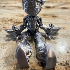 a metal figurine sitting on top of a table