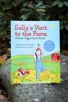 a children's book about yoga sits on a rock