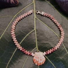 This bracelet has been handcrafted with a Sunrise shell and high quality Kauai Kahelelani shells, diligently sorted to create a symmetric, intricate HerringBone style. Strung on 50lb' test braided nylon line, this piece is very durable and strong and can be worn in fresh or salt water.  The 14kt gold filled lobster claw clasp makes it easy to put on or remove, but will not come off undesirably during activities.  Length: 8' inches    Bracelet will arrive in gift box. TO LEARN MORE ABOUT THESE RA Elegant Handmade Shell Bracelets, Handmade Shell-shaped Bracelets For Gifts, Shell Oyster Bracelet As Gift, Handmade Pink Shell Bracelets, Hand-strung Shell Jewelry For Gifts, Hand-strung Shell Jewelry As Gift, Sunrise Shell, Puka Shell, Shell Bracelet