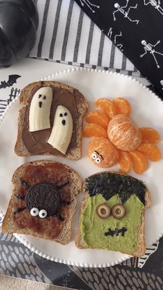 a white plate topped with slices of toast covered in fruit and veggie faces