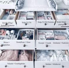 the drawers are organized with baby clothes and other things to put in them for storage