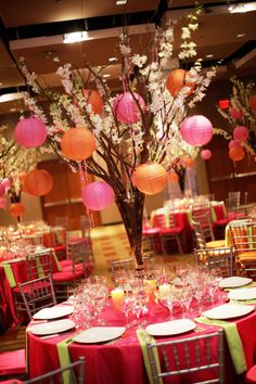 the tables are decorated with paper lanterns and flowers