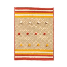 an orange and yellow striped rug with small buttons on it's side, in front of a white background