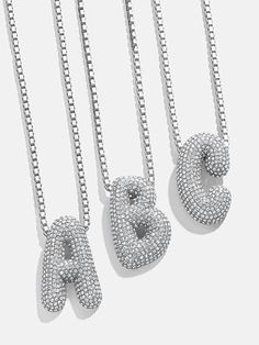 Orders placed through 11/29 11:59pm EST will be delivered by 12/19.Opt for this classic initial necklace with a modern twist. The Pavé Bubble Initial Necklace features a box chain attached to an initial crystal pendant. Each letter is crafted in a fun, 3D-inspired bubble font. Choose your initial or that of a loved one and stack it every single day.