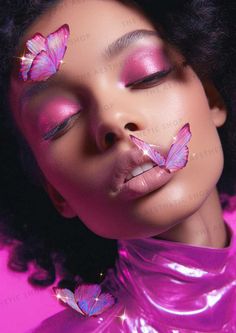 a woman with pink butterflies on her nose and eyes, in front of a pink background