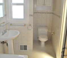 a bathroom with a sink, toilet and bathtub next to a window in it