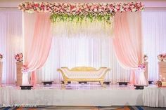 a wedding stage decorated with pink and white flowers