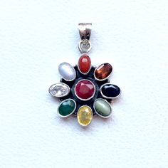 Genuine 925 Sterling Silver Navratan Pandent  Gemstone - Ruby , Emerald , Blue Sapphire, Yellow Sapphire, Hessonite, Cats Eye, Coral, Pearl, Cubic Zircona.  Stones setted - 9 pieces QTY - 1 piece in this listing. The navratna or nine gems influencing the nine planets are:  Ruby  =  Sun ,  Pearl = Moon, Red Coral = Mars, Emerald = Mercury,  Yellow Sapphire = Jupiter, zircon = Venus, Blue Sapphire = Saturn,  Hessonite = Rahu , Cat''s Eye = Ketu . Sterling Silver Healing Pendant Gemstones, Sterling Silver Pendant Gemstones For Healing, Multicolor Oval Stone Setting Jewelry, Multicolor Oval Jewelry With Stone Setting, Spiritual Silver Gemstone With Oval Pendant, Spiritual Silver Oval Pendant Gemstone, Multi-stone Pendant Gemstones For Jewelry Making, Traditional Multi-stone Gemstones As Gift, Traditional Multi-stone Gemstones For Gifts