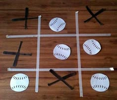 a wooden table topped with cut out baseballs and bats