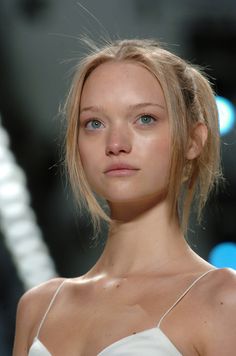 a woman with blonde hair and blue eyes on the catwalk at a fashion show