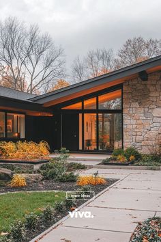 a modern house with large windows and landscaping