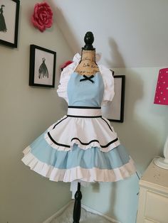 a mannequin dressed up in a blue and white dress