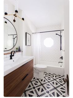 the bathroom is decorated in black and white