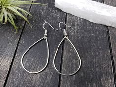 "These super lightweight teardrop hoop earrings feature 40mm x 26mm brass open teardrops. Choose silver-plated or gold-plated! These minimalist geometric earrings will complement any outfit, and are lightweight enough for all day wear! The earrings measure 2.5 inches from the bottom of the teardrop to the top of the ear wires. The gold earrings have hypoallergenic gold-plated surgical steel ear wires, while the silver earrings have hypoallergenic surgical steel ear wires. These earrings are incr Everyday Metal Teardrop Earrings, Hypoallergenic Metal Drop Teardrop Earrings, Hypoallergenic Metal Teardrop Drop Earrings, Hypoallergenic Metal Teardrop Earrings, Metal Teardrop Hoop Earrings For Pierced Ears, Everyday Metal Teardrop Drop Earrings, Adjustable Nickel-free Teardrop Earrings, Minimalist Metal Teardrop Hoop Earrings, Minimalist Teardrop Metal Hoop Earrings