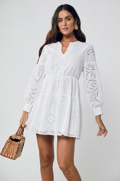 Dreamy summer staple. The June Ballon Sleeve Mini Dress screams summer vacay. Our White Broderie Anglaise 100% Cotton is light and effortless. With a lightly elasticated waist, loose fitting cuff sleeves this Aline Mini is featuring a V neck is fully lined and perfect for casual dinner on those balmy nights relaxing o Bohemian V-neck Crochet Dress For Day Out, Chic V-neck Crochet Dress For Day Out, Casual Hollow Out Maxi Dress, Spring V-neck Maxi Dress With Hollow Out Details, Chic Hollow Out Maxi Dress For Spring, Chic Spring Maxi Dress With Hollow Out Details, V-neck Hollow Out Maxi Dress For Spring, Spring Hollow Out V-neck Maxi Dress, Hollow Out V-neck Maxi Dress For Spring