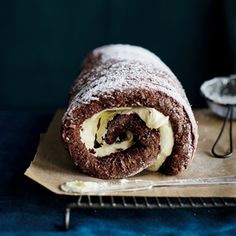 there is a chocolate roll with cream filling on it