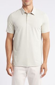 A smart-casual look for warm weather, this solid-hued polo is made from smooth, stretchy performance jersey that keeps you feeling comfortable. Button half placket Spread collar Short sleeves 88% polyester, 12% polyurethane Machine wash, tumble dry Imported Casual Fitted Golf Tops, Spring Solid Polo Shirt With Collared Neckline, Collared Moisture-wicking Tops For Summer, Moisture-wicking Collared Tops For Summer, Collared Tops With Moisture-wicking For Summer, Summer Business Casual Polo Shirt, Casual Solid Color Polo Shirt With 4-way Stretch, Casual Golf Tops With Collared Neckline, Casual Collared Golf Tops