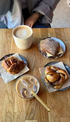 three pastries and two cups of coffee on a table