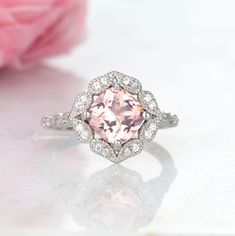 Beautiful Vintage Inspired Morganite Ring ►Made of solid sterling silver with a rhodium finish (925) ►Accented with simulated diamonds (CZ) Center Stone: Morganite Stone Cut: Cushion Color: Peachy- Pink Gem size: 7.0 mm Carat Weight: 1.28 ct. Stone Creation: Simulated ►Matching band can be purchased here: https://www.etsy.com/listing/815340258/chevron-wedding-band-sterling-silver?ga_search_query=curved&ref=shop_items_search_11&frs=1 ✓ 100% Nickel-Free ✓ Hypoallergenic ✓ Comfort Fit ✓ Fre Classic Morganite Diamond Ring For Wedding, Classic Morganite Diamond Wedding Ring, Classic Morganite Rings For Wedding, Sapphire Ring With Halo Setting, Classic Morganite Wedding Ring, Classic Morganite Diamond Ring With Center Stone, Morganite Round Cut Promise Ring, Morganite White Gold Wedding Rings, Classic Morganite Diamond Ring With Round Cut