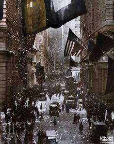 an image of people walking in the rain with flags and cars on the side walk