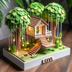 a paper model of a tree house with stairs and trees on the sides, surrounded by greenery