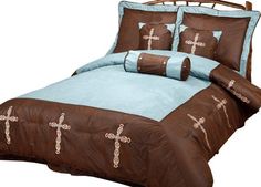 a bed with brown and blue comforters on it