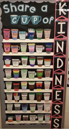 a sign that says share a cup of kindness on it with cups in front of it