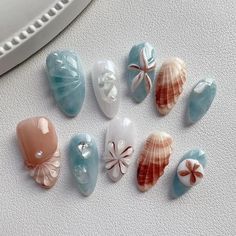 Introducing 'Coastal Breeze,' a stunning set of press-on nails inspired by the serene beauty of the seaside. These nails feature a harmonious blend of oceanic blue and sandy beige tones, adorned with intricate seashell and starfish designs. Each nail is meticulously crafted to capture the essence of beachside tranquility, making 'Coastal Breeze' the perfect accessory for those who love to bring a touch of the coast wherever they go. Dive into elegance and let your nails reflect the calming charm Charmed Nails, Nail Art Beach, Bali Nails, Seashell Nails, Nails Beach, Beachy Nails, Designer Nails, Nails Designer, Nails Inspired