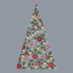 a cross stitch christmas tree with red and green decorations