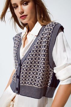 Introducing our Knitted Cropped Vest with Chic Rib Trim in Blue – a stylish and versatile addition to your fall wardrobe, perfect for creating fashionable outfits.   Key Features:     Material:  Crafted from a blend of 54% Polyester, 20% Acrylic, 20% Polyamide, and 6% Wool, this knitted vest offers both warmth and style.   Cropped Design:  This vest features a cropped length and ribbed style trims, creating a trendy and fashionable look.   Front Closure:  The front closure with buttons adds a touch of elegance and practicality to the vest.   Relaxed Fit:  Designed for a relaxed fit, it provides comfort and style for your daily wear.   Sleeveless Style:  The sleeveless design makes it a versatile layering piece for various outfits.   Fine Knit:  The fine knit adds a soft and cozy texture to Fall Wear, Knitted Vest, Fashionable Outfits, Cropped Vest, Crisp White Shirt, Trendy Fall, Faux Leather Skirt, Outfits Casual, Knit Vest