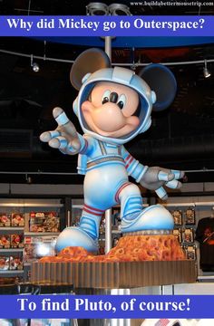 the mickey mouse statue is on display in front of a store sign that says why did mickey go outer space? to find pluto, of course