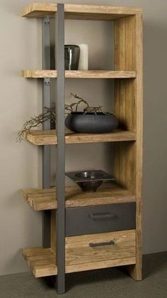 a wooden shelf with some vases and other items on it's shelves in front of a wall