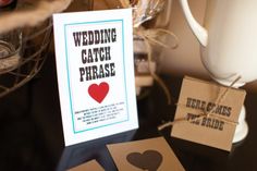 there is a card that says wedding catch phrase next to two cards with hearts on them