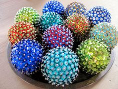 there are many colorful balls in the bowl