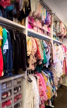 the closet is full of children's clothing and shoes