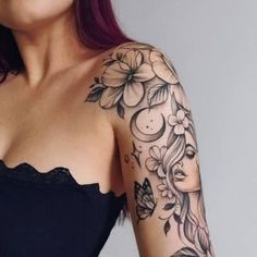 a woman with red hair wearing a black dress and tattoos on her arm is looking at the camera