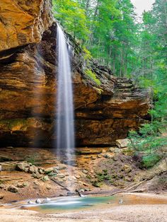 a waterfall in the middle of a forest