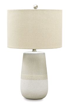 a white table lamp with a beige shade on the bottom and an off - white base