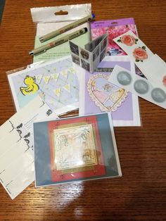 many different cards and envelopes on a table